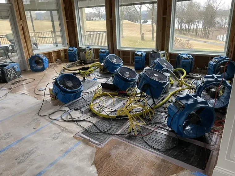 Air movers drying a room after water damage