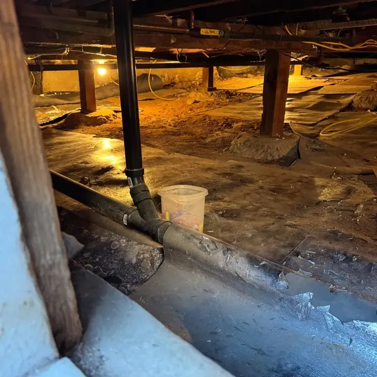 Standing water being pumped from the crawl space of a Santee, CA home